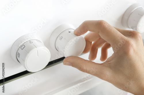 Woman Using Oven Controls