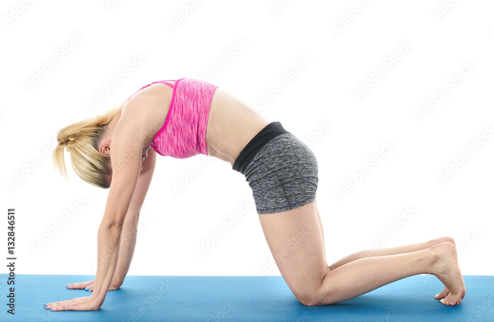 Woman making pilates mat exercises