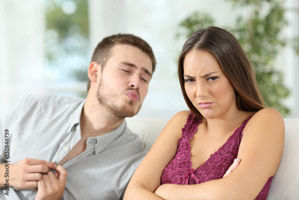 Angry woman rejecting a sex offer from her boyfriend Angry woman rejecting a sex offer from her boyfriend
