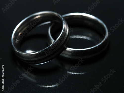 Two used wedding rings on black background