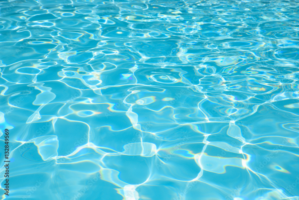 Beautiful ripple water surface with sun reflection in swimming pool