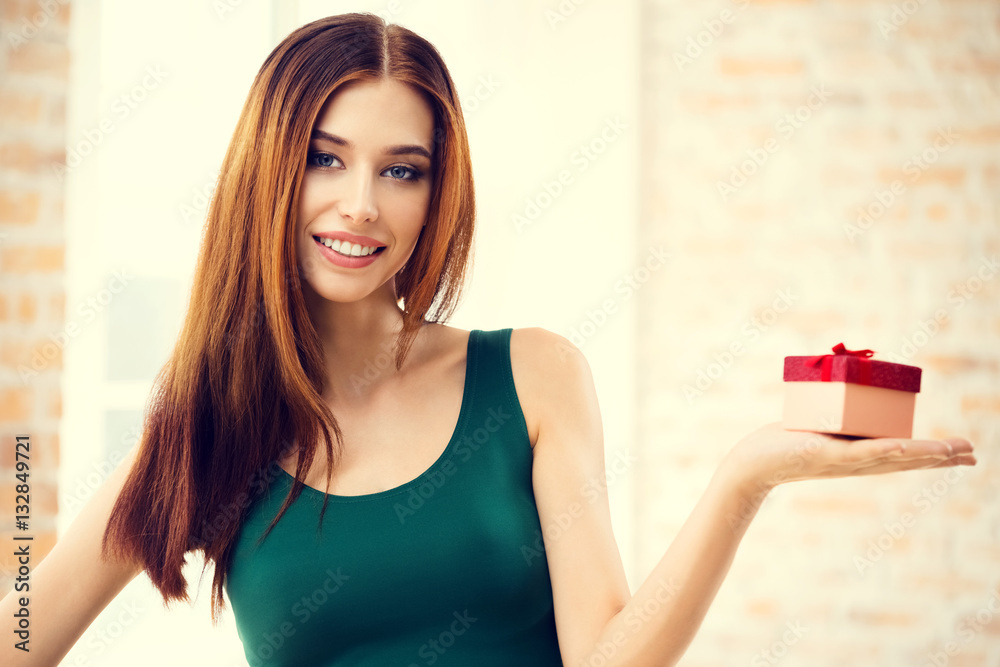 Young happy smiling woman with gift, at home Young happy smiling woman with gift, at home