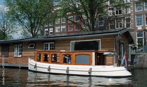 Netherlands, Amsterdam. Types of cities, buildings, canals and boats. Views on the water background. Amsterdam in the spring. #132851371