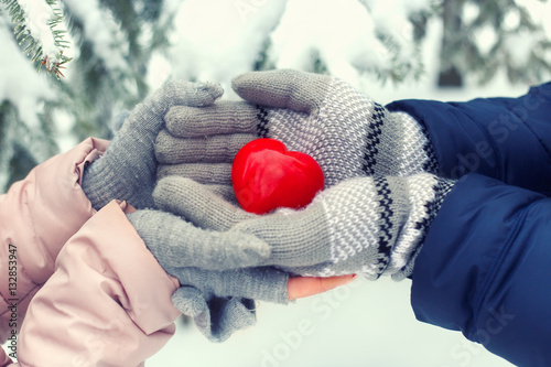 Hands holding red heart outdoor
