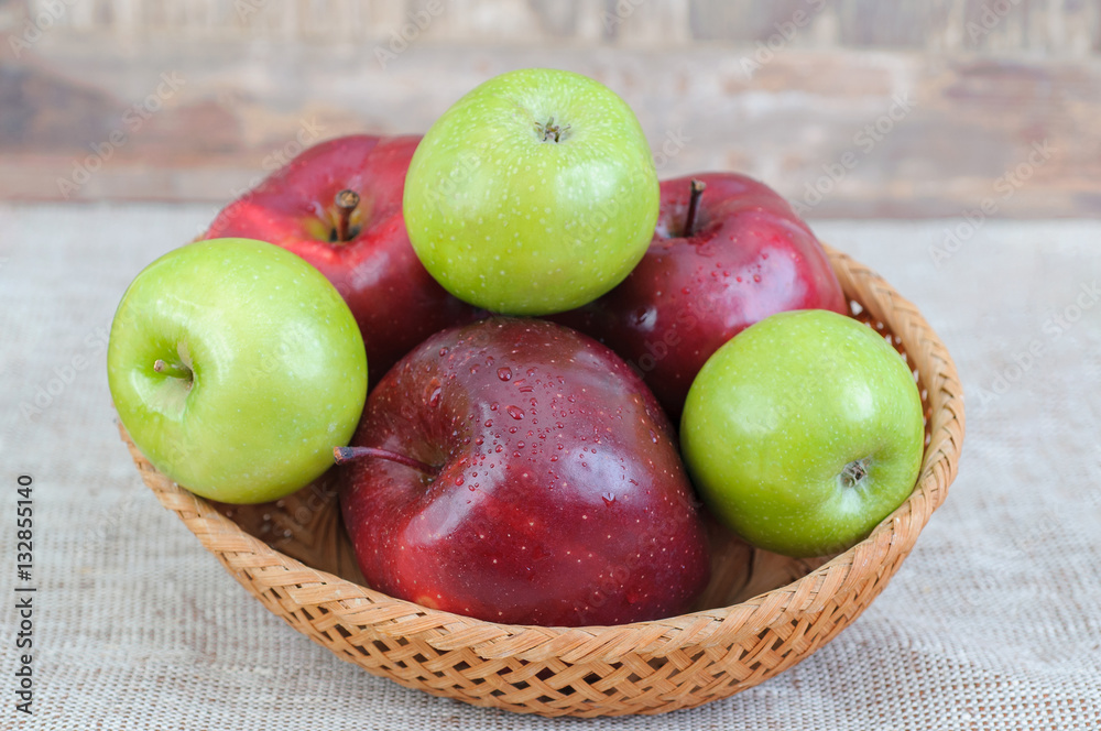 Fresh Apples in a wooden basket on wooden background Fresh Apples in a wooden basket on wooden background