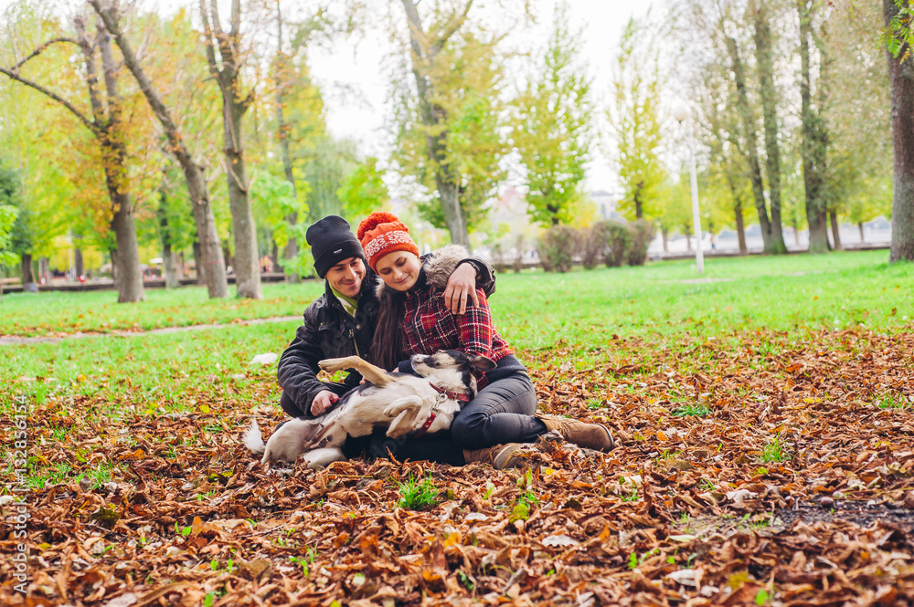 couple walking a dog park