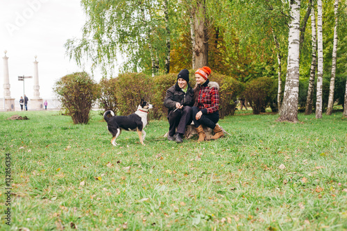 couple walking a dog park