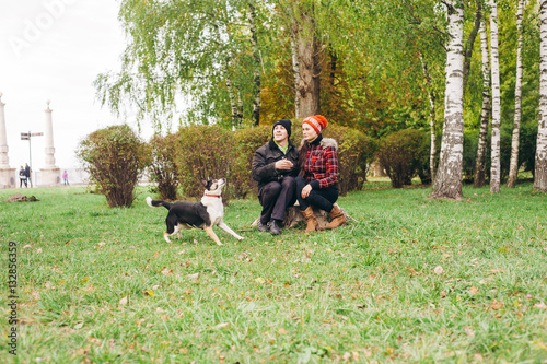 couple walking a dog park