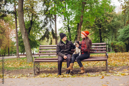 couple walking a dog park