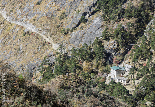 Ancient Buddhist stupa on the path at the entrance to the Phortse village - Everest region, Nepal, Himalayas photo