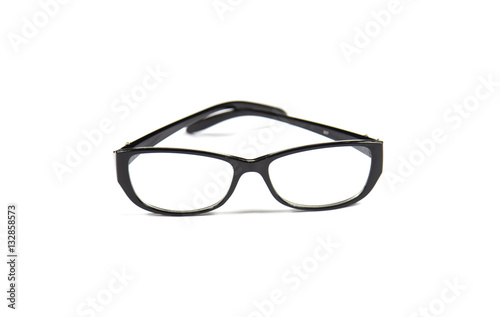 eyeglasses and notebook on wood background, black and white with
