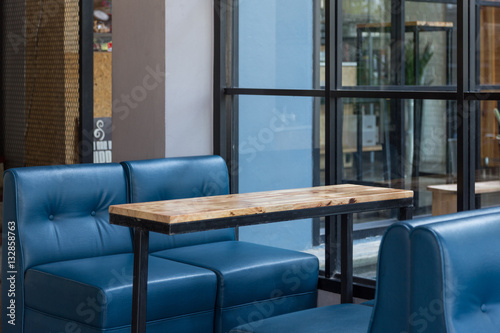 Empty wooden table and blue sofa restaurant