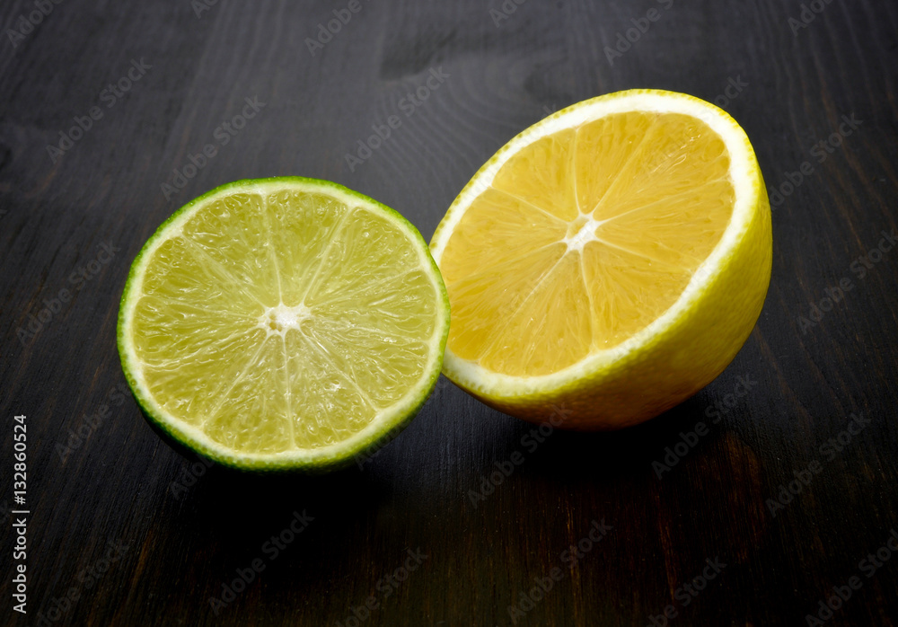 Lemon and lime on dark wooden background Lemon and lime on dark wooden background