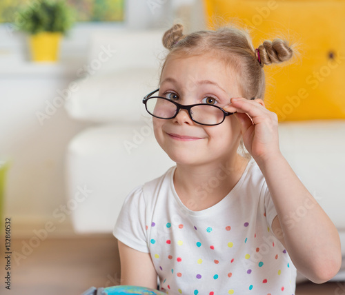 Pretty child girl at home dreaming of travel and tourism, explor photo