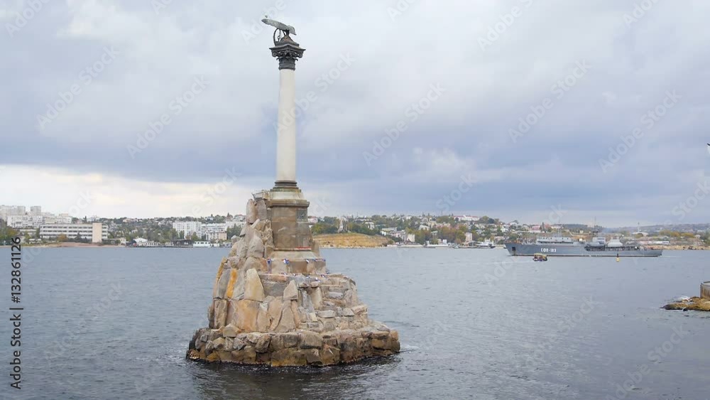 Monument to the Scuttled Ships Towering Over the City in Sevastopol. the Symbol of the City. in the Background is a Warship Monument to the Scuttled Ships Towering Over the City in Sevastopol. the Symbol of the City. in the Background is a Warship