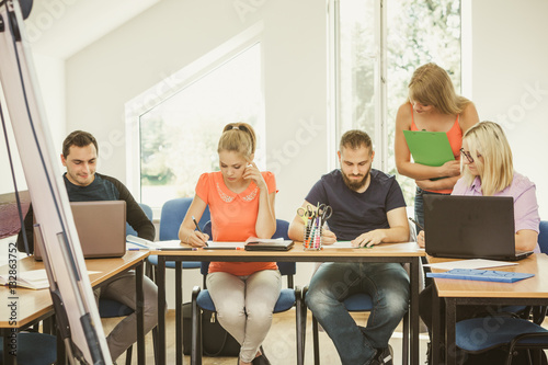 Students and teacher tutor in classroom