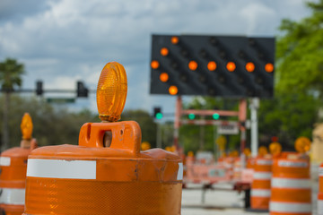 Road closed signs detour traffic temporary street work orange lighted arrow and barrels