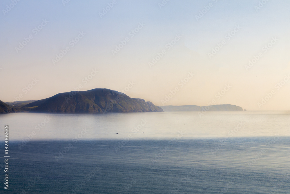 Serene wide open sea with cliffs in the distance Serene wide open sea with cliffs in the distance
