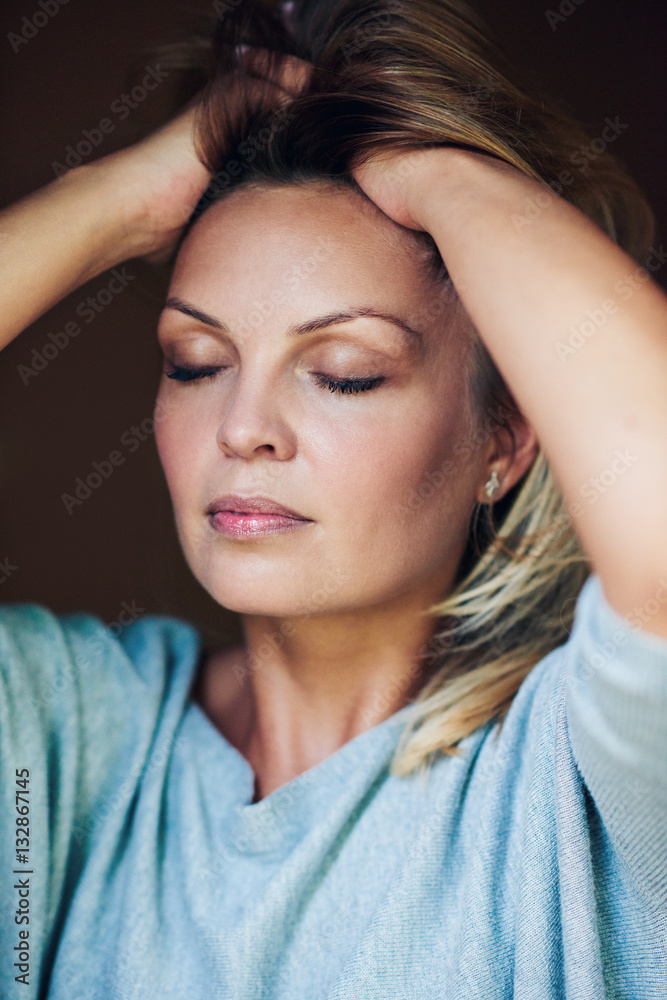 Beautiful young woman feeling her soft hair Beautiful young woman feeling her soft hair