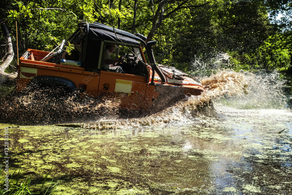 Land Rover driving through a lake