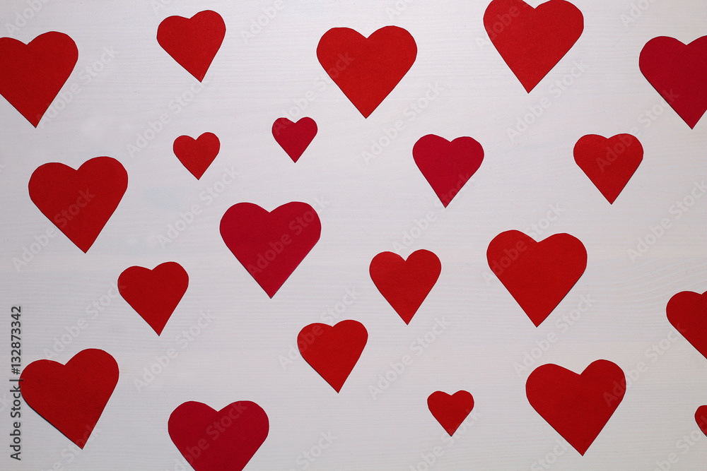 Postcard on Valentine's Day - a lot of red and pink hearts on a white-lined wooden background.