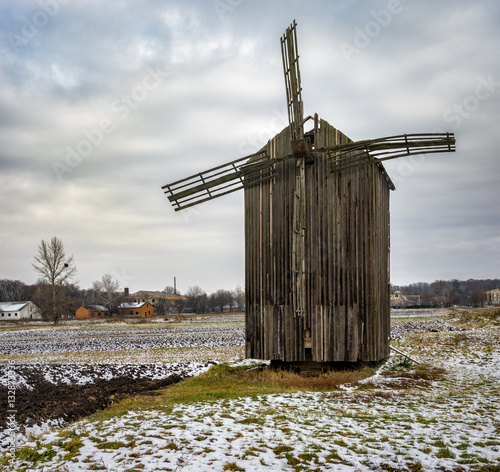 Late autumnal landscape with an ancient wooden windmill in Dikanka village, Ukraine photo