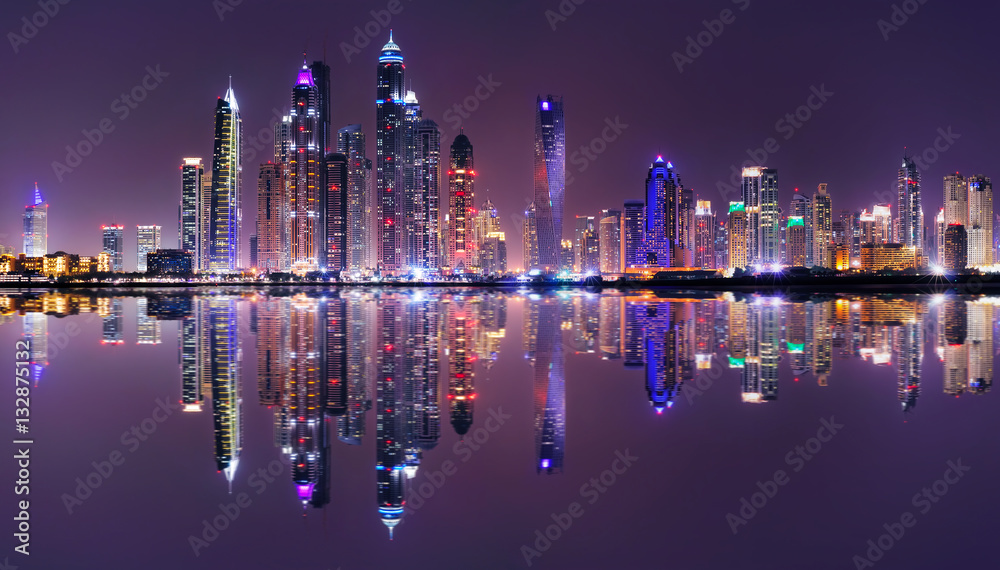 Obraz premium Amazing night panorama of Dubai Marina. Multiple highest skyscrapers of the world with residential buildings, Dubai, United Arab Emirates