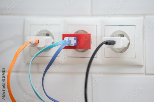 Wires plugged into electric socket

