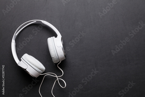 Headphones on leather desk table photo