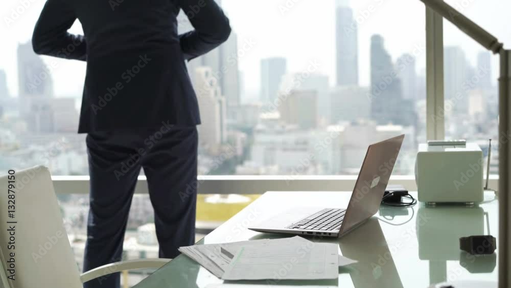 Young businessman finishing working on laptop, stretching arms and relaxing by desk in office
Young businessman finishing working on laptop, stretching arms and relaxing by desk in office