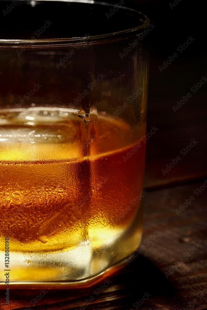 Glass whiskey and ice Background.Food and drinks texture concept Glass whiskey and ice Background.Food and drinks texture concept