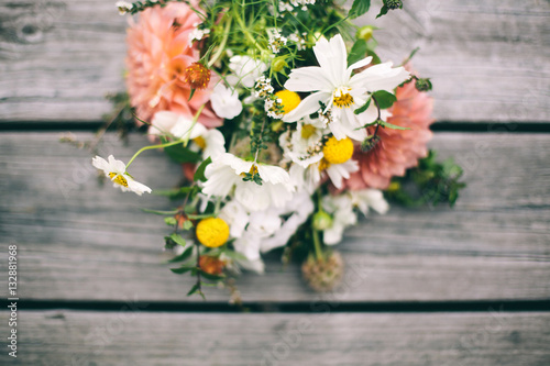 Bunch of flowers on a wooden table photo