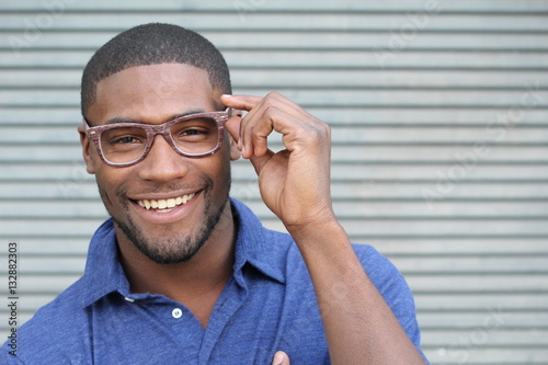 Εκτύπωση καμβά African holding his eyeglasses and smiling