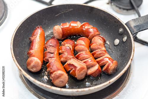 juicy grilled sausages in a pan