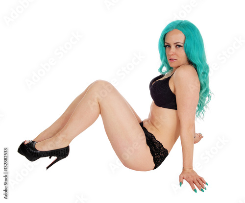 Woman sitting on floor in underwear.