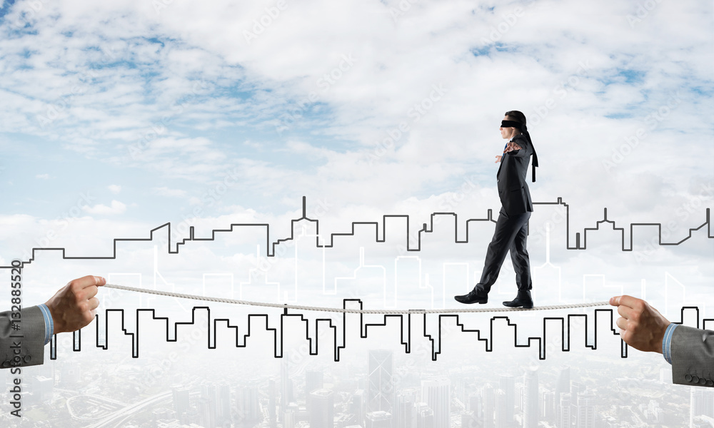 Business concept of risk support and assistance with man balancing on rope Business concept of risk support and assistance with man balancing on rope