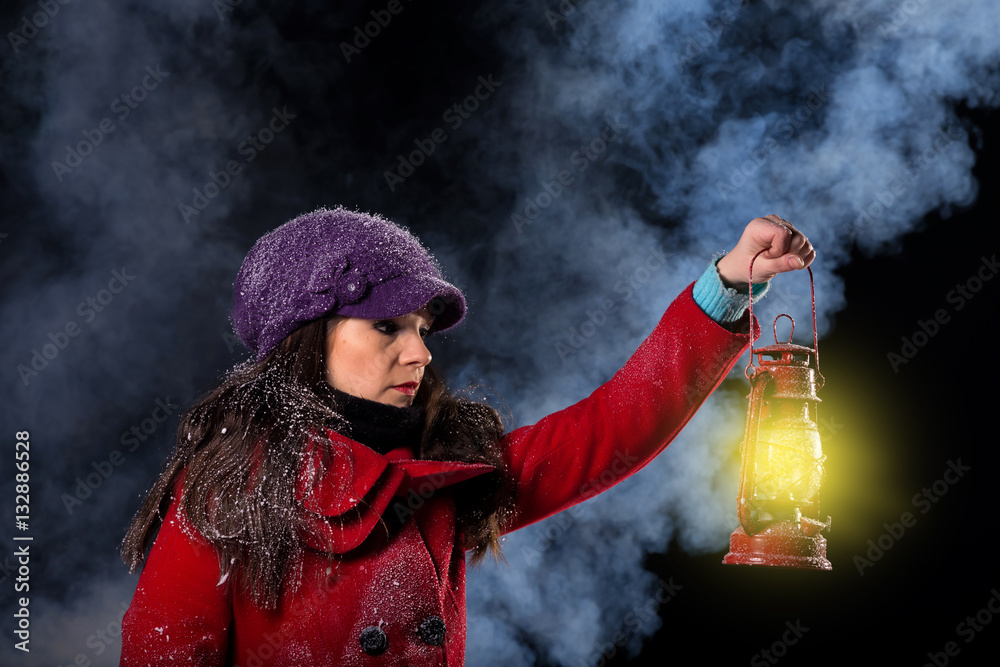 young woman holding lantern in the snowy dark night Stock Photo | Adobe ...