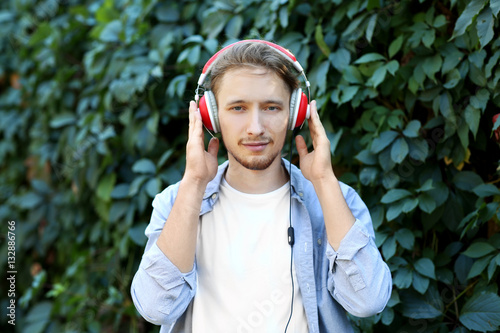 Handsome young man listenin...