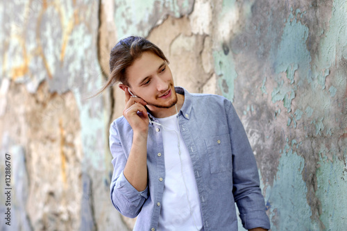 Handsome young man listenin...