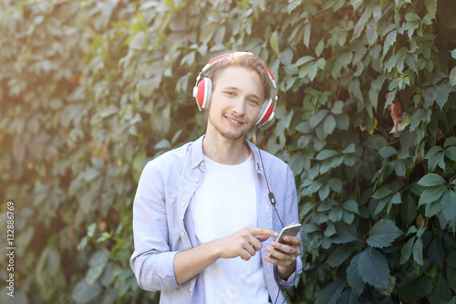 Handsome young man listenin...