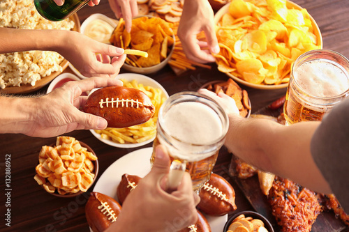 Sticker Close up view of hands taking snacks from plates during party