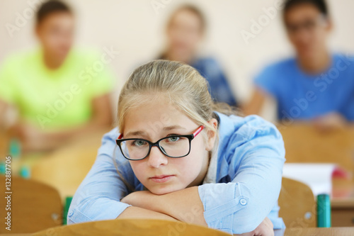 Student with group of classmates in classroom photo