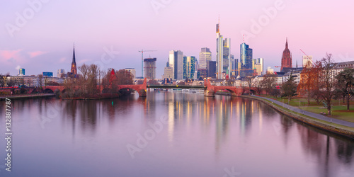 Picturesque panoramic view of business district with skyscrapers and mirror reflections in the river at sunrise, Frankfurt am Main, Germany © Kavalenkava