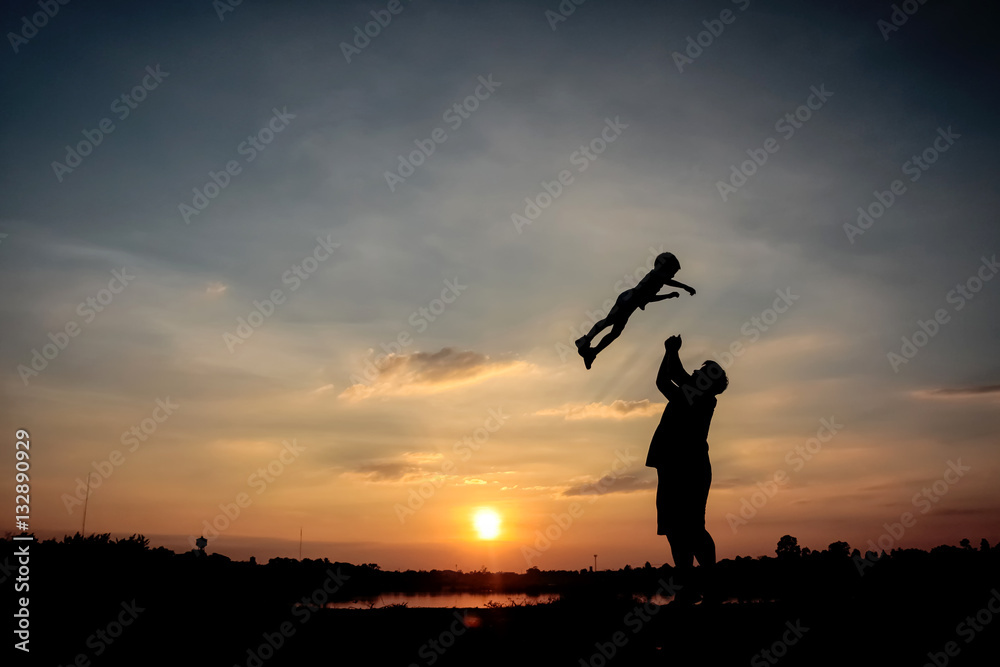 Family concept, Silhouette of father throwing son into the sky.