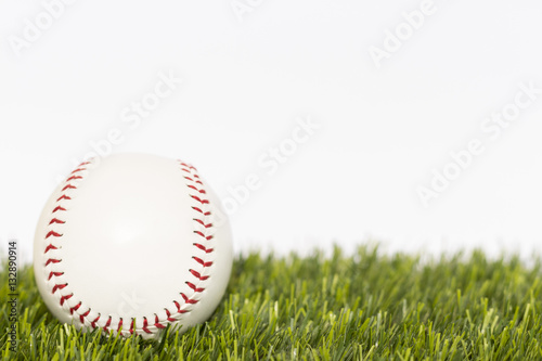 Baseball ball lays on a grass