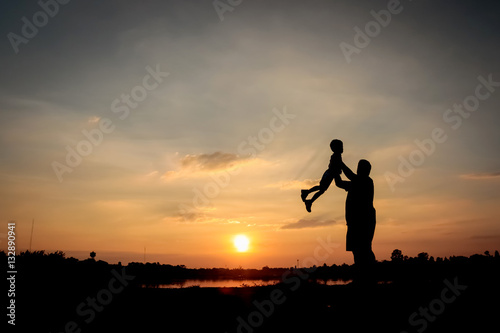 Family concept, Silhouette of father throwing son into the sky.