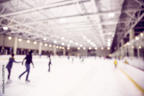 ice skating indoor rink. defocused skating rink with people. blurred background due to the concept. empty space for your text © EvgeniiAnd