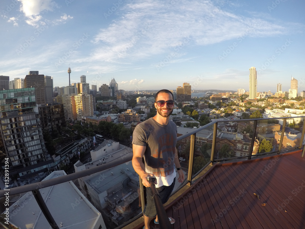 Man taking a selfie with Sydney Skyline on background, Australia