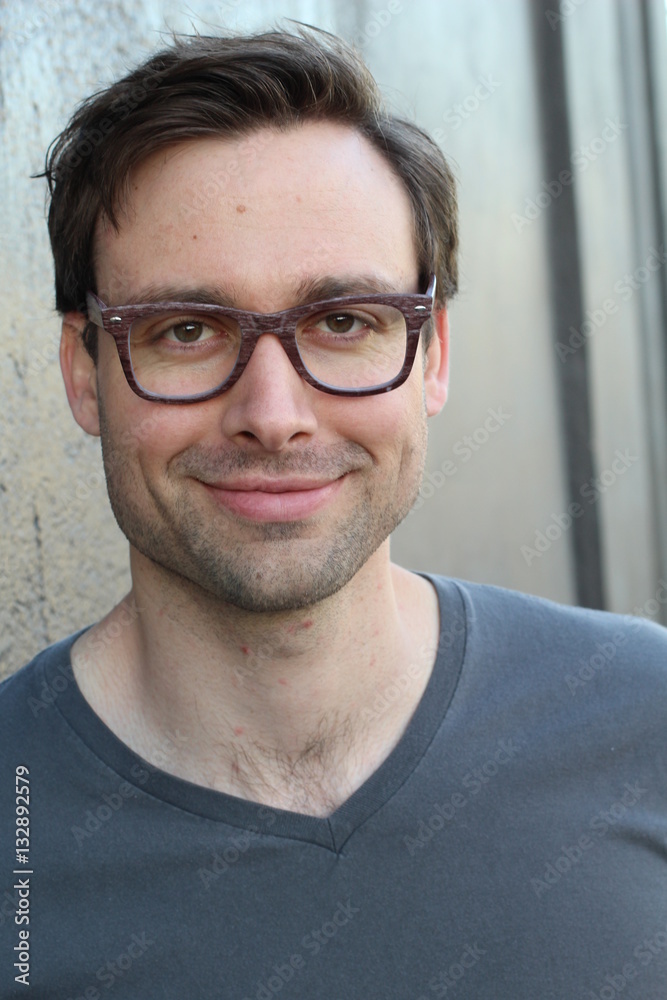 Natural good looking young man with glasses smiling Natural good looking young man with glasses smiling