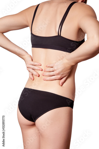 Closeup view of a young woman with pain in back. isolated on white background. © khosrork